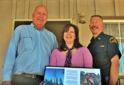 Supervisor Couch and Fire Chief Marshall make presentation of office furniture to Mountain Communities Chamber of Commerce Executive Director Rachel Unell